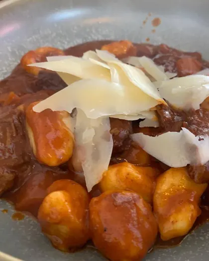 Gnocchi in tomato ragu with shaved parmesan