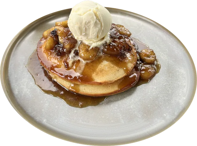 Caramelised banana pancakes with a scoop of ice cream and caramel sauce